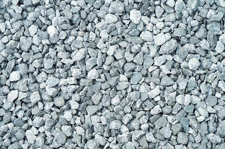 压缩灰色砾石侵蚀卵石颗粒状岩石宏观地面视图粒状材料特写背景图片