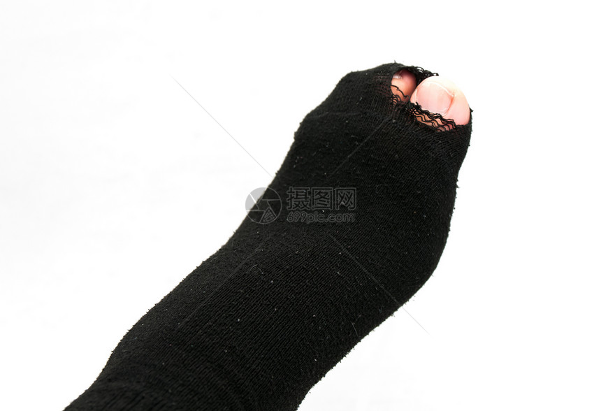 在旧袜子和撕破的脚里短袜拇指白色脚趾图片