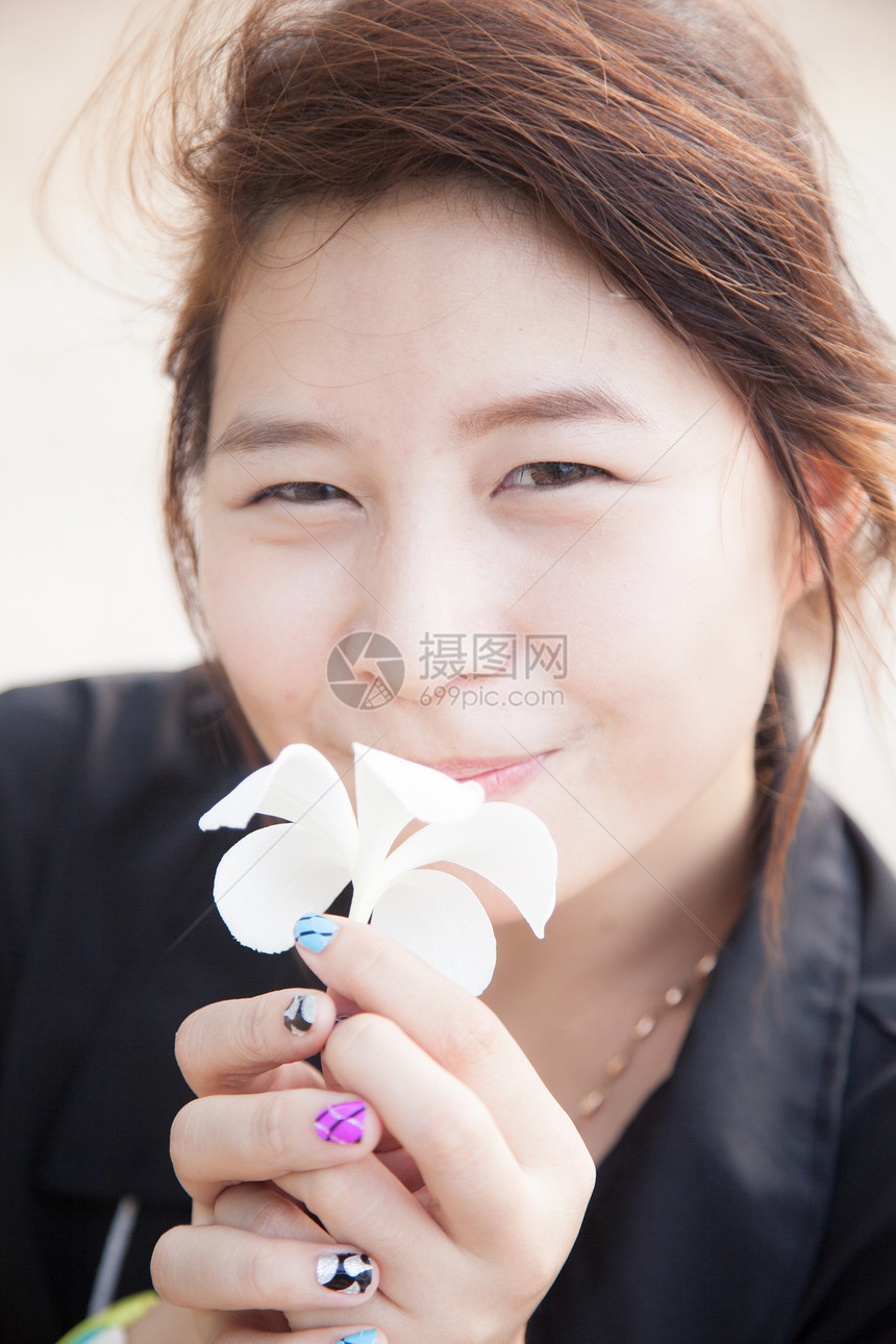 亚洲女性黑衬衫 穿着白花的衣物植物幸福微笑女士喜悦白色情感头发成人女孩图片