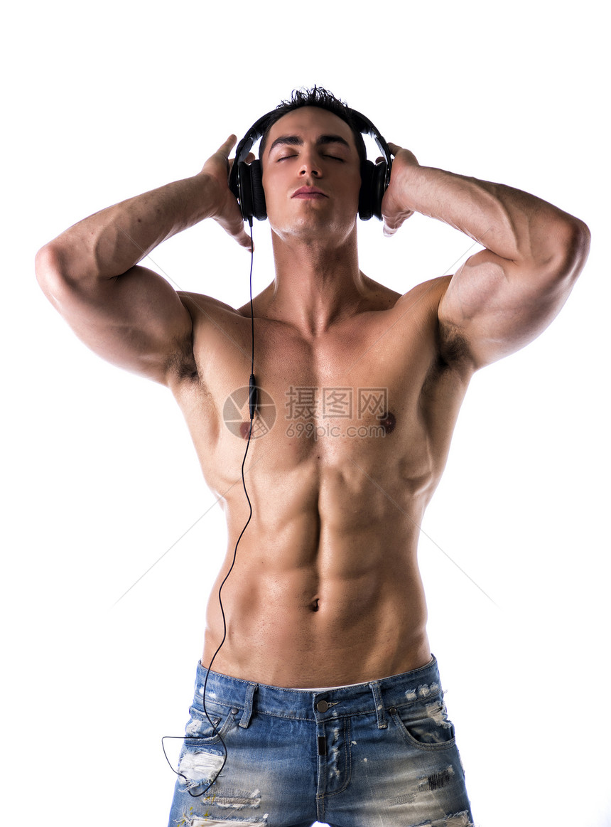 肌肉人站立 用耳机收听音乐膀子眼睛工作室身体胸部白色牛仔裤躯干红色黑色图片