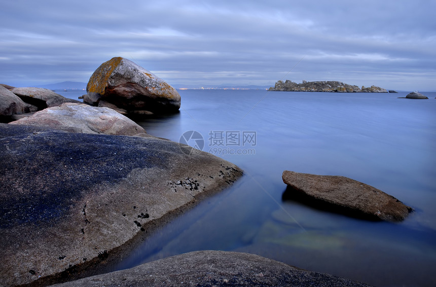 平静橙子旅游海岸风景日落旅行季节快门岩石支撑图片