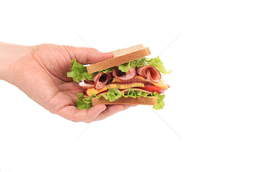 新鲜三明治在手边图片