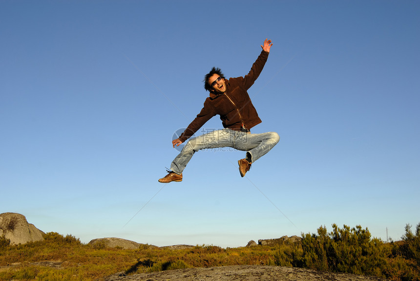 跳跃男人蓝色运动员空气喜悦男性植被天空自由假期图片