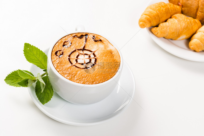 大杯咖啡和盘子上的羊角面包香气桌子饮料甜点食物咖啡店泡沫早餐小吃报纸图片