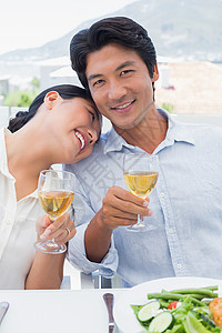 快乐的一对夫妇一起喝白酒吃饭时间女士酒精女性倾斜晚餐住所闲暇沙拉肩膀背景图片