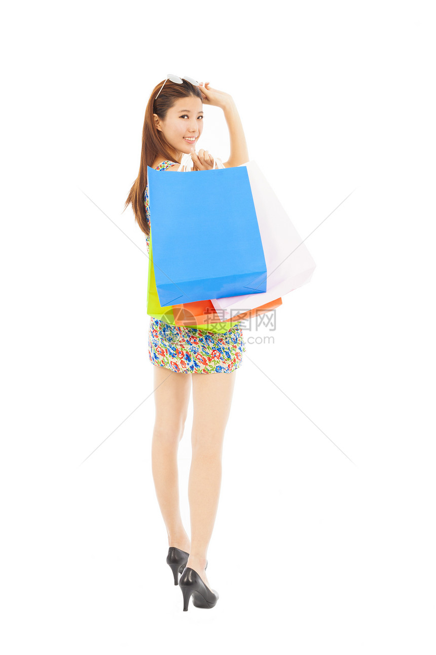 带购物袋的快乐年轻女子姿势消费者幸福女士乐趣销售展示零售女性成人图片
