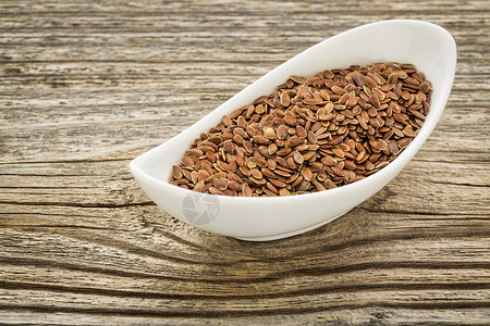 棕褐麻麻种子棕色陶瓷制品养分粮食木头亚麻白色高清图片