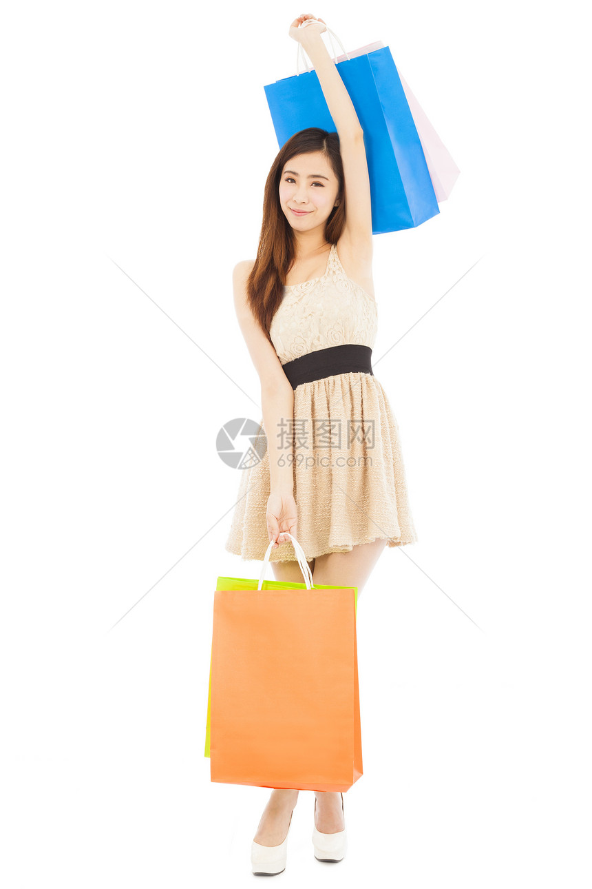 带购物袋的快乐年轻女子微笑展示头发成人顾客购物者幸福女性乐趣女孩图片