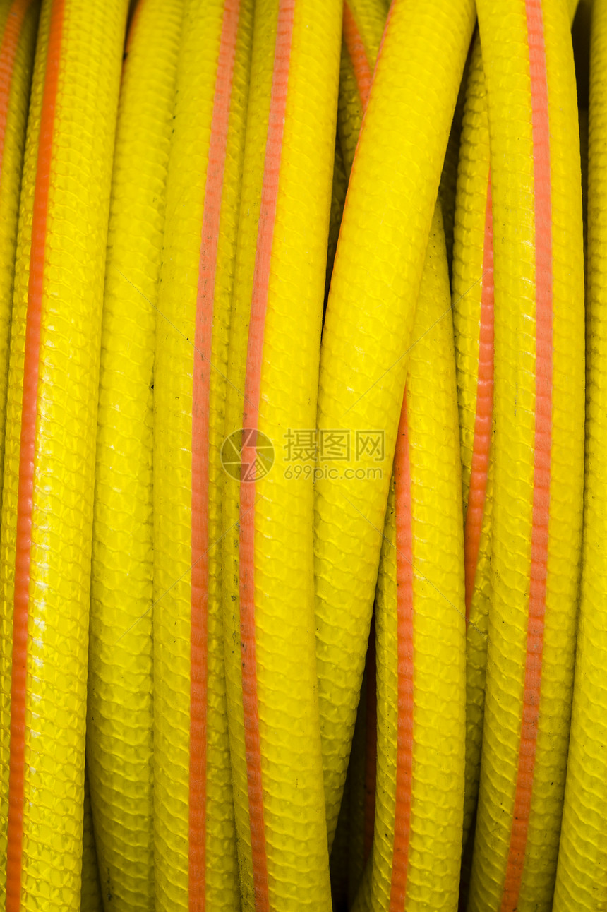 黄色和橙色水管灌溉管道花园塑料软管技术橡皮园艺植物管子图片