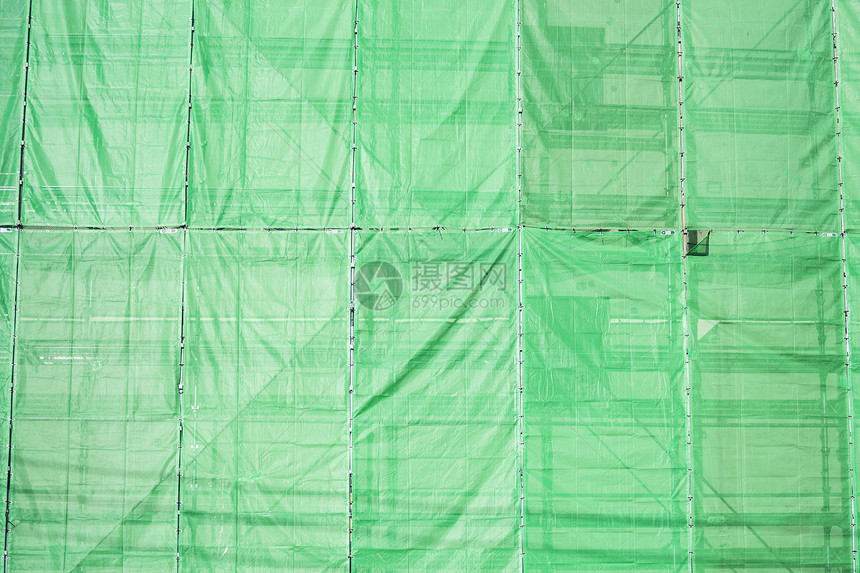 建筑建筑工地的绿色布面植物蓝色材料力量进步天空建筑物床单职场工作图片
