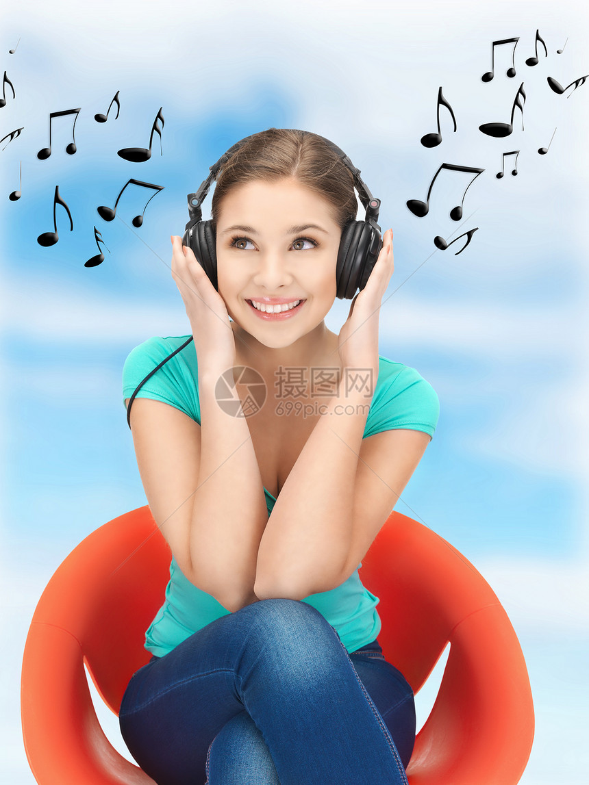 使用大耳机的快乐少女青少年听力闲暇耳机音乐幸福乐趣女性享受音乐播放器图片