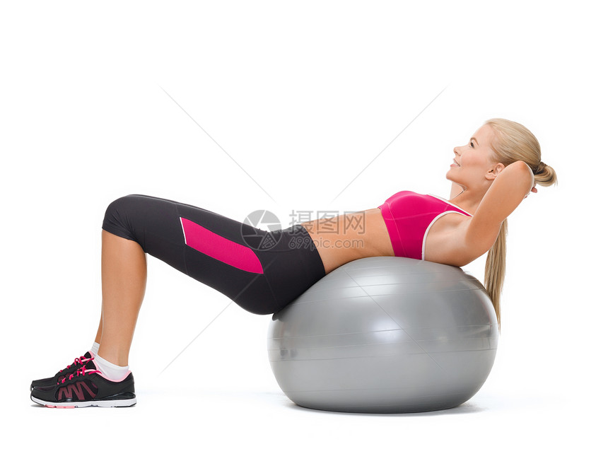 带着健身球的微笑着的妇女锻炼说谎体操有氧运动讲师女孩身体运动装肌肉女性图片