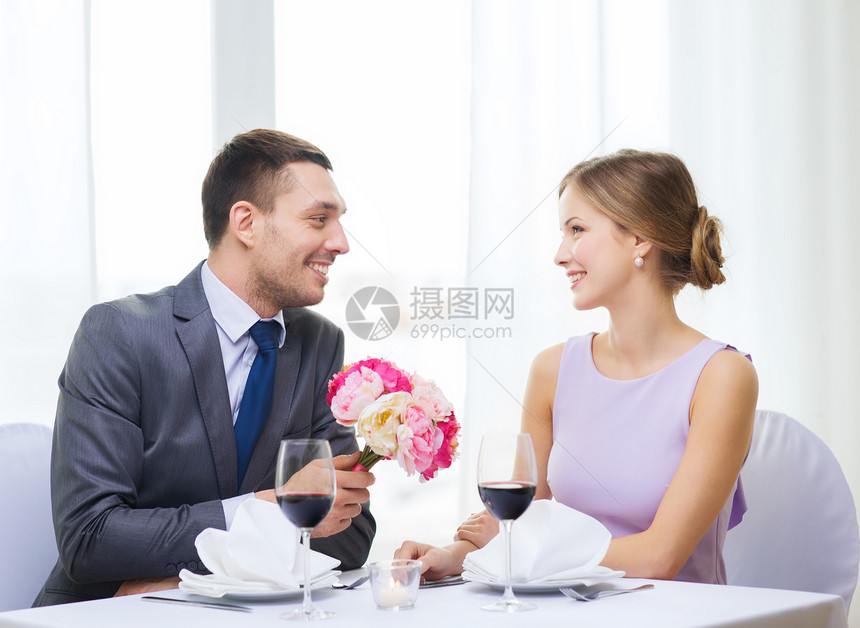 男人笑着在餐厅送花束男朋友生日家庭眼镜丈夫牡丹女士周年纪念日展示图片