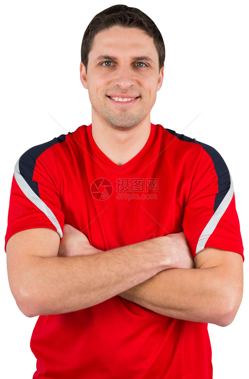 英俊的足球运动员在看摄影机运动服活动快乐运动红色男人齿轮播放器微笑男性图片