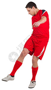 年轻足球运动员踢球运动红色播放器运动服活动男性男人齿轮背景图片