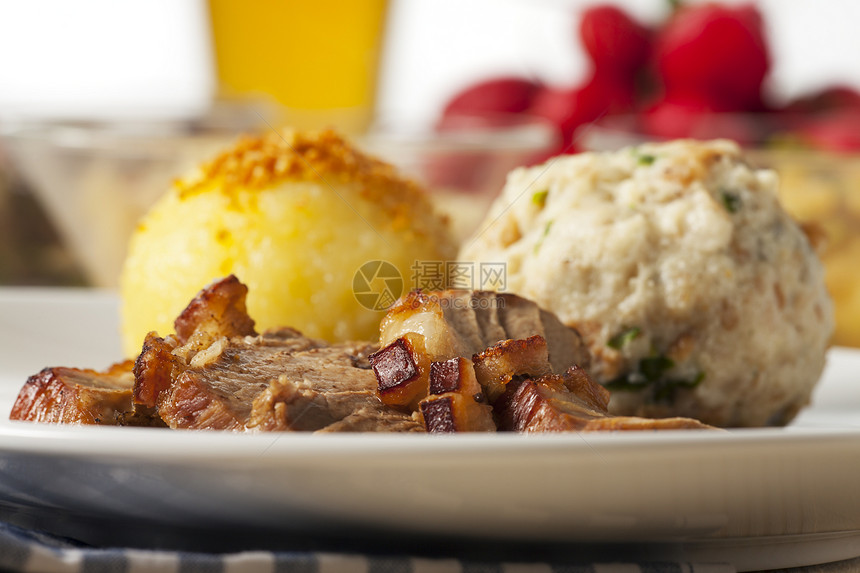 巴伐利亚烤猪肉 加子腰部白色盘子美食香菜棕色饺子食物烹饪油炸图片