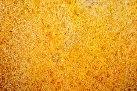 泡沫肥皂黄色洗涤橙子肥皂水纹理宏观白色背景图片