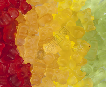 黄色糖果分割线宝石熊团体糖果红色味道凝胶店铺食物橙子黄色绿色背景