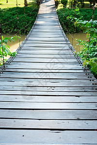 木林长绳桥黄色热带溪流公园小路绿色吊桥棕榈木头吊坠背景
