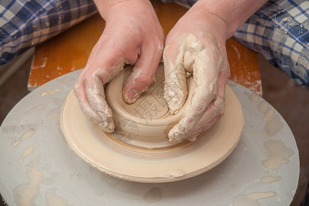 陶匠的手手工艺术作坊专注工作杯子女士陶瓷陶器血管背景