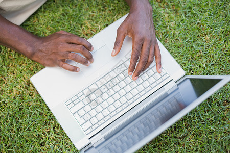 男人用笔记本电脑在花园里放松男性家庭生活闲暇技术黑色背景图片