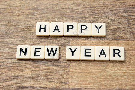 新年快乐字母木头瓷砖背景图片