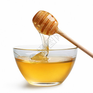 玻璃碗中的蜂蜜食物白色甜食木头黄色橙子液体高清图片