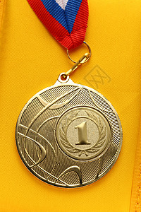 金属奖牌黄色蓝色运动徽章圆形竞赛白色荣誉丝带胜利背景图片