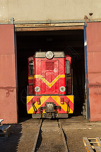 古老的列车离开技术大楼背景图片