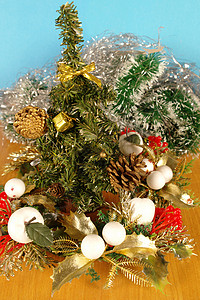 圣诞节装饰红色松树木板桌子玩具礼物锥体叶子浆果绿色背景图片
