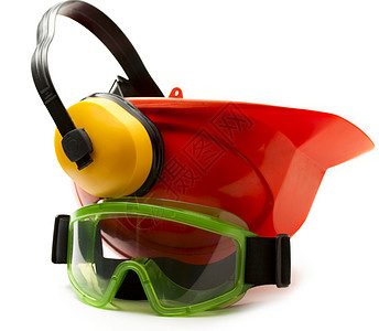 带耳机和护目镜的红色安全头盔眼睛安全帽眼镜捍卫者工业塑料工作头饰衣服建造背景图片