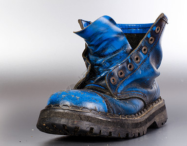 旧旧靴子蕾丝皮革黑色蓝色背景图片
