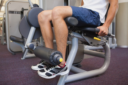 使用称重机处理腿部重量的健身人男人身体训练运动服运动肌肉竞技健身房调理调子背景图片