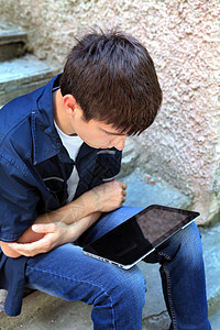 配有平板电脑的青少年网络手机小伙子孤独药片展示脚步男性工具屏幕背景图片