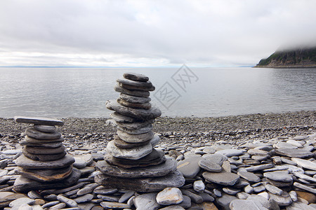 牛首胜境首湾背景的石头堆平衡冥想峡湾岩石天空艺术海滩海洋雕塑海岸背景