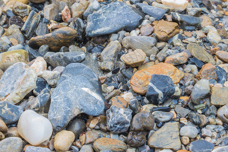 孔洞材料黑色卵石海滩墙纸岩石石头背景图片