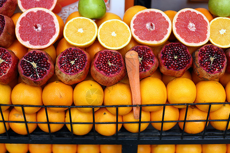 火鸡石榴水果摊石榴市场展示摊位橙子热带火鸡食物红色商业背景