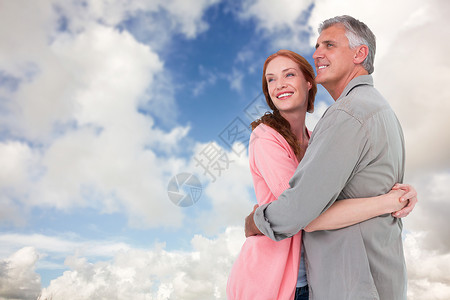 搭配情侣拥抱和微笑的复合形象夫妻快乐亲密感情怀休闲女士红发多云感情男性背景图片