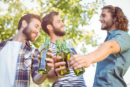 时髦的朋友一起喝啤酒公园旅行聚会瓶子胡须阳光男人微笑农村社交背景图片