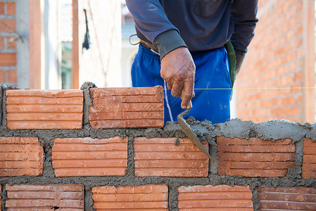 工人建造泥瓦工房屋房子工具石匠建筑学砖块男人建设者工作水泥砂浆背景图片