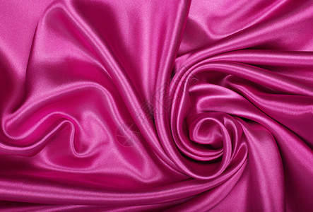 平滑优雅的粉色丝绸或作为底底边的折叠曲线版税布料窗帘海浪材料玫瑰织物投标背景图片