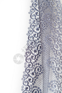 装饰性银色花环白色宏观艺术装饰品织物衣服边缘边界脆弱性背景图片