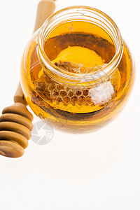 带蜂窝的新鲜蜂蜜橙子健康宏观黄色草本植物金子液体药品绿色蜂蜡背景图片