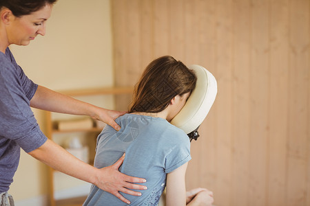 女青年在椅子上按摩治疗师女士客户女性紧张诊所考场双手压力咨询背景图片