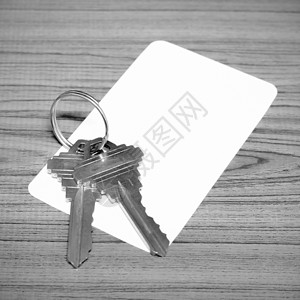 名片和密钥黑白色音调风格后台项链房子钥匙会员安全边界资格会议扣子背景图片