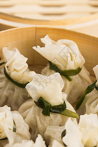 小饺子竹蒸汽船中中国的燕子猪肉水梅食物饮茶竹子橙子时间地面盖子美食背景