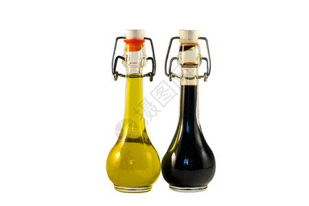 调味醋两瓶葡萄酒醋和橄榄油味道醒酒器调味品处女营养调味礼物瓶子玻璃蔬菜背景