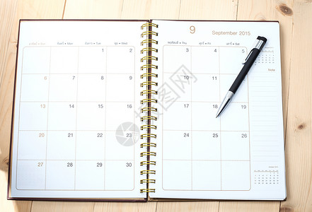 日历和笔备忘录商业笔记白色工作写作时间背景图片