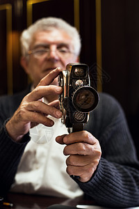 高级男子控制录像摄影机男士拍摄电影古董摄像师背景图片