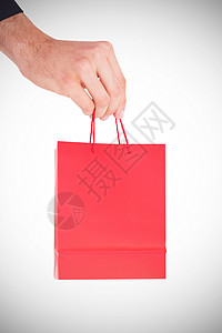 手拿着礼物袋红色展示购物零售背景图片